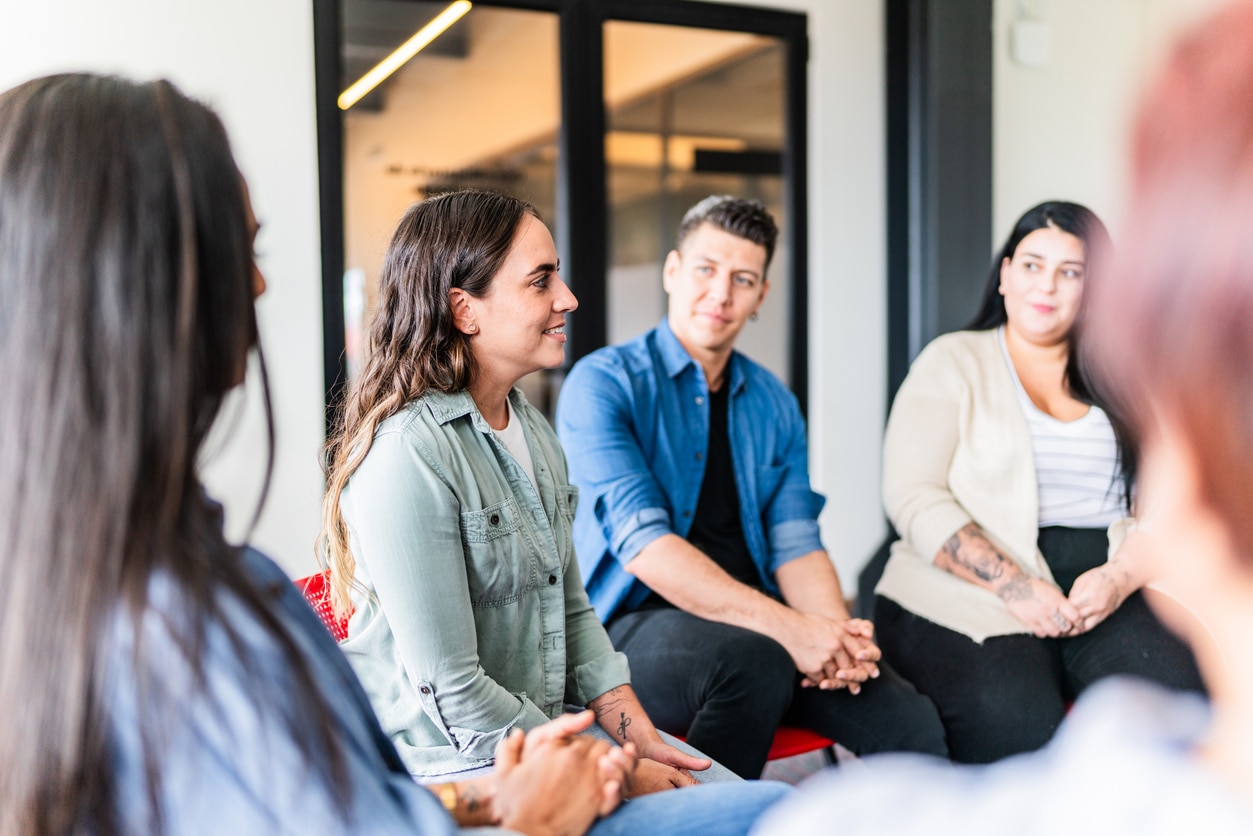 Woman introducing herself in group therapy at mental health center